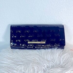 Betsy Johnson Betsyville black Paton clutch with bows designing the entire bag